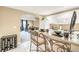 Kitchenette with bar, white cabinets and adjoining Gathering room, perfect for casual dining and entertaining at 1455 Oglethorpe Run Ln, Suwanee, GA 30024