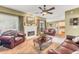 Spacious living room with a fireplace, comfortable leather seating, and view to kitchen at 1455 Oglethorpe Run Ln, Suwanee, GA 30024