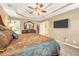 Main bedroom featuring decorative trey ceiling, TV, walk-in closet, and en suite bathroom at 1455 Oglethorpe Run Ln, Suwanee, GA 30024