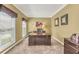 Bright office space with natural light from a large window, carpet floors, and ample desk space at 1455 Oglethorpe Run Ln, Suwanee, GA 30024