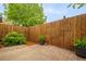 Nice backyard featuring a wooden fence, brick patio, and greenery; perfect for outdoor relaxation and entertaining at 3065 Windcrest Ct, Alpharetta, GA 30022