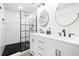 Beautiful bathroom with a dual sink vanity, stand alone shower with glass and black hardware, and white subway tile at 3065 Windcrest Ct, Alpharetta, GA 30022