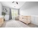 Bright bedroom with a crib, rocking chair, natural light, and grey accents creates a calm and inviting space at 3065 Windcrest Ct, Alpharetta, GA 30022