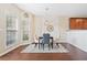 Bright dining area featuring a modern light fixture, two windows, and new floors at 3065 Windcrest Ct, Alpharetta, GA 30022