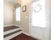 Light and airy entryway with wood floors, white trim, stairs and front door with sidelight at 3065 Windcrest Ct, Alpharetta, GA 30022