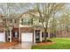 Charming brick townhome with a one-car garage, small porch, and manicured front lawn with fresh pine straw at 3065 Windcrest Ct, Alpharetta, GA 30022