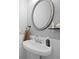 Stylish half bathroom featuring modern fixtures, a decorative mirror, and trendy patterned wallpaper at 3065 Windcrest Ct, Alpharetta, GA 30022