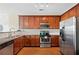 Well-appointed kitchen featuring stainless steel appliances, granite countertops, and rich wood cabinetry at 3065 Windcrest Ct, Alpharetta, GA 30022
