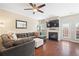 Cozy living room with a fireplace, ceiling fan, stylish decor, and access to outdoor living at 3065 Windcrest Ct, Alpharetta, GA 30022