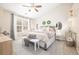 Serene main bedroom featuring a ceiling fan, accent wall, ample natural light, and modern decor at 3065 Windcrest Ct, Alpharetta, GA 30022