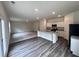 Bright open floor plan showcasing kitchen with island and spacious living space at 7748 Sudbury Cir, Covington, GA 30014