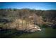 Aerial view showcasing waterfront properties with docks along a serene lake surrounded by trees at 1280 Tynecastle Way, Sandy Springs, GA 30350