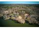 Stunning aerial view of lakefront homes with docks, nestled in a lush wooded area, offering privacy at 1280 Tynecastle Way, Sandy Springs, GA 30350