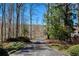 Tree-lined driveway leading to a secluded property at 1280 Tynecastle Way, Sandy Springs, GA 30350