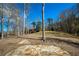 Stone patio with scenic lakeside views and an expansive lawn and surrounding trees at 1280 Tynecastle Way, Sandy Springs, GA 30350