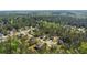 Aerial view of a quiet neighborhood with homes surrounded by vibrant green trees at 15 Sloane Ct, Covington, GA 30016