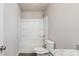 Bathroom showcasing a white shower-tub combo, toilet, and granite vanity top at 15 Sloane Ct, Covington, GA 30016