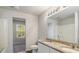 Bathroom with double vanity and granite countertops, view into adjacent room at 15 Sloane Ct, Covington, GA 30016