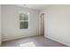Bedroom with neutral walls, plush carpeting, and a window, providing ample natural light at 15 Sloane Ct, Covington, GA 30016