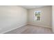 Bedroom with neutral carpet and walls, window with views provides natural light at 15 Sloane Ct, Covington, GA 30016