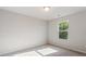 Bright bedroom featuring neutral walls, plush carpeting, and a window offering natural light at 15 Sloane Ct, Covington, GA 30016
