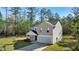 A charming two-story home featuring a two-car garage, a well-kept lawn, and beautiful landscaping at 15 Sloane Ct, Covington, GA 30016