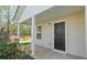 Inviting front porch and entrance features a black front door with white pillars at 15 Sloane Ct, Covington, GA 30016