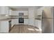 Beautiful bright kitchen featuring stainless steel appliances, granite counters, and white cabinetry at 15 Sloane Ct, Covington, GA 30016