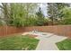 Fenced backyard featuring a playground on a concrete pad, accessible via a concrete walkway, and lawn at 2376 Academy Ne Ct, Atlanta, GA 30345