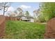 Private backyard with sprawling lawn, mature trees and privacy fence at 2376 Academy Ne Ct, Atlanta, GA 30345