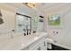 Modern bathroom with white cabinets, marble countertop, black hardware, and tiled shower at 2376 Academy Ne Ct, Atlanta, GA 30345