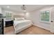 Primary bedroom features a ceiling fan, wood floors and plantation shutters at 2376 Academy Ne Ct, Atlanta, GA 30345