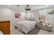Bedroom with a patterned duvet cover, hardwood floors, and a gray cushioned bench at 2376 Academy Ne Ct, Atlanta, GA 30345