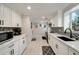Bright kitchen features white cabinets, quartz countertops, mosaic backsplash and stainless steel appliances at 2376 Academy Ne Ct, Atlanta, GA 30345