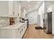 Bright kitchen features white cabinets, stainless appliances, chevron backsplash and quartz countertops at 2376 Academy Ne Ct, Atlanta, GA 30345