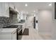 Modern kitchen boasts sleek white cabinets, quartz countertops, and stainless steel appliances at 2376 Academy Ne Ct, Atlanta, GA 30345