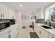 Bright kitchen features white cabinets, quartz countertops, mosaic backsplash and stainless steel appliances at 2376 Academy Ne Ct, Atlanta, GA 30345