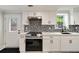 This home features a modern kitchen with white cabinets, stainless steel appliances and quartz countertops at 2376 Academy Ne Ct, Atlanta, GA 30345