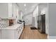 Bright kitchen features white cabinets, stainless appliances, chevron backsplash and quartz countertops at 2376 Academy Ne Ct, Atlanta, GA 30345