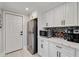 Bright kitchen with stainless steel appliances, white cabinets, and quartz countertops at 2376 Academy Ne Ct, Atlanta, GA 30345