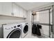 A spacious laundry room with white cabinets, modern washer/dryer, and wire shelving at 2376 Academy Ne Ct, Atlanta, GA 30345