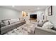 Spacious living room with plush gray sofas, area rug, and neutral color palette at 2376 Academy Ne Ct, Atlanta, GA 30345