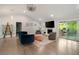 Bright living room featuring a fireplace, sleek shelving, and patio access, perfect for entertaining at 2376 Academy Ne Ct, Atlanta, GA 30345