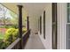 Inviting covered porch with brick siding, black columns, and a railing, offering a relaxing outdoor space at 2376 Academy Ne Ct, Atlanta, GA 30345