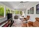 Sunroom with lounge chairs, entertainment center and access to the outside deck at 2376 Academy Ne Ct, Atlanta, GA 30345
