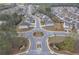 Expansive aerial view of a well-planned community with a roundabout entrance and lush landscaping at 5372 Fountain Head Ln, Auburn, GA 30011
