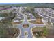 High-angle aerial showcases a Primary-planned neighborhood featuring homes with manicured lawns and tree-lined streets at 5372 Fountain Head Ln, Auburn, GA 30011