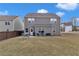 Fenced backyard with a patio, lush lawn, and neighborhood views at 5372 Fountain Head Ln, Auburn, GA 30011