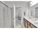 Bathroom showcasing a glass shower and double sink vanity with a view to the bedroom at 5372 Fountain Head Ln, Auburn, GA 30011