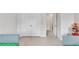 Spacious bedroom with carpeted flooring, white double doors, and good lighting at 5372 Fountain Head Ln, Auburn, GA 30011